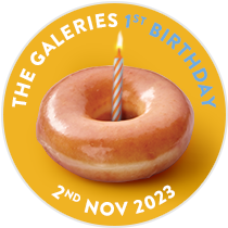 A single Original Glazed Doughnut with a candle in the middle to signify the The Galeries Store's first Birthday, celebrating a year in this location